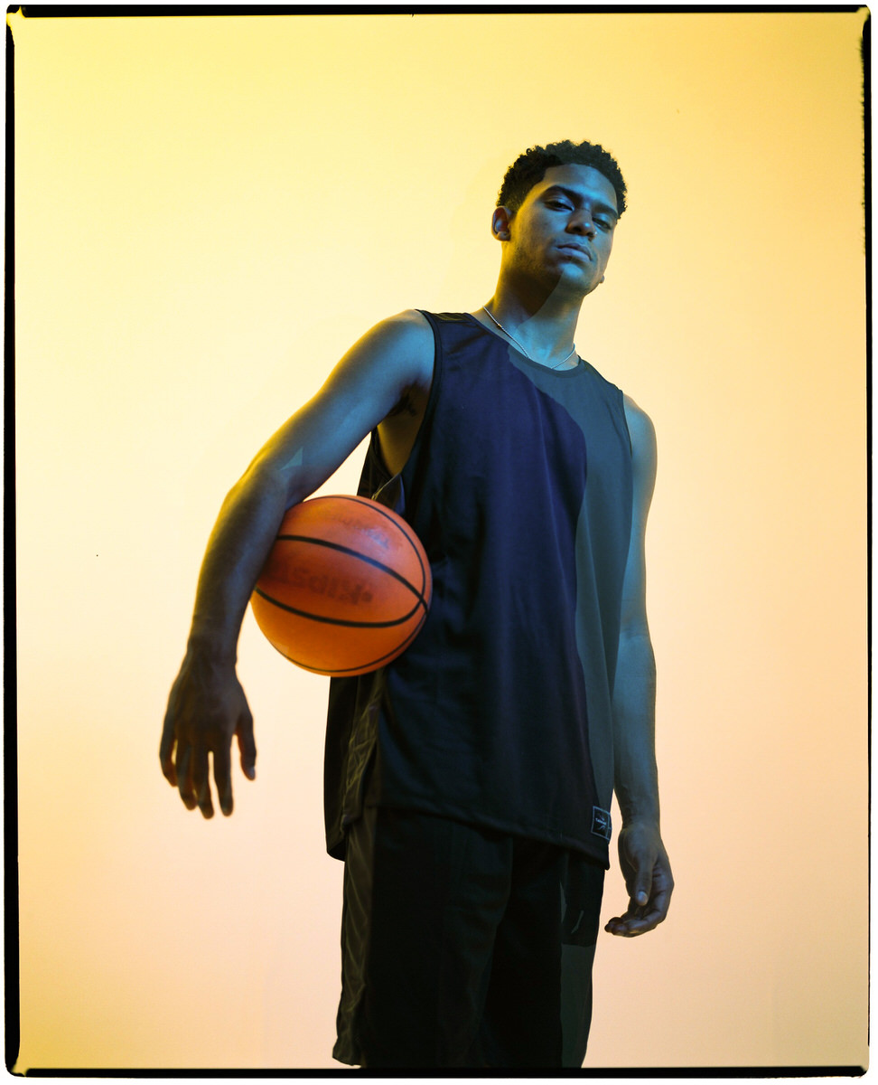 Determined black basketball player with ball